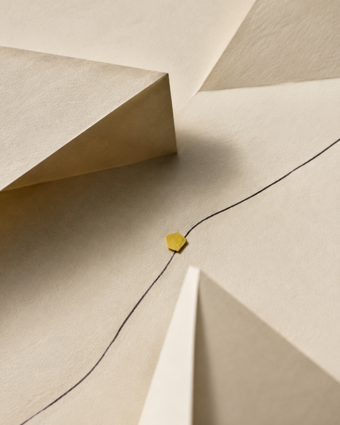 Folded paper planes with a yellow marker and a drawn directional line